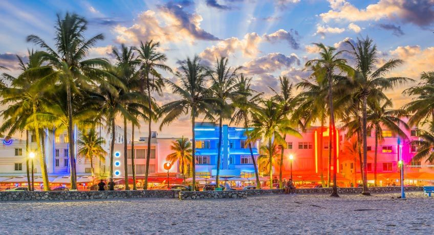 Art deco buildings lit up at dusk in Miami