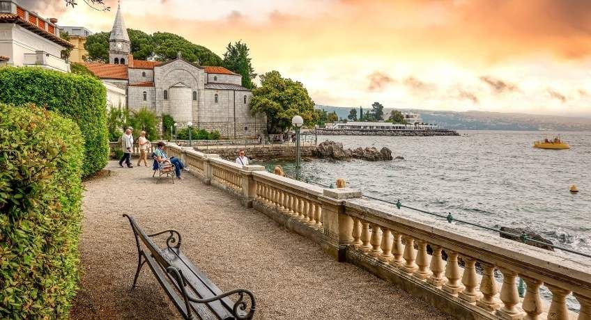 Bench with views overlooking a lake and a stone balcony
