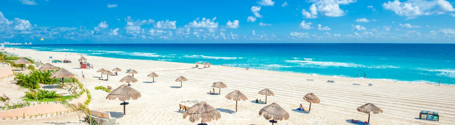 White sands & turquoise waters of a beach in Cancun, Mexico