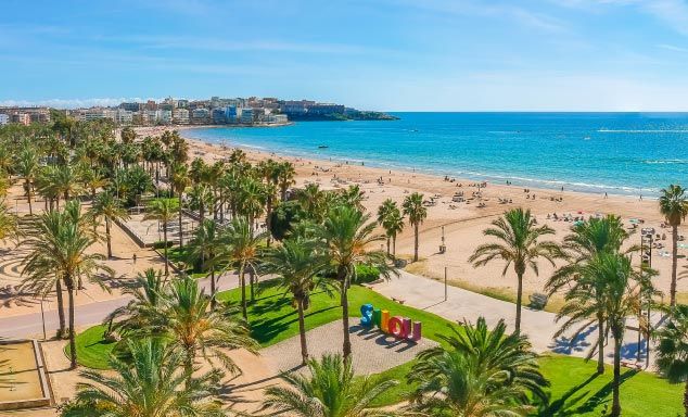 Palm trees line the beach in the Costa Dorada