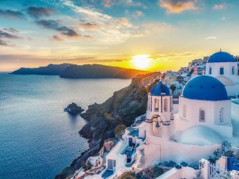 Blue domed churches overlooking the sea in Greece