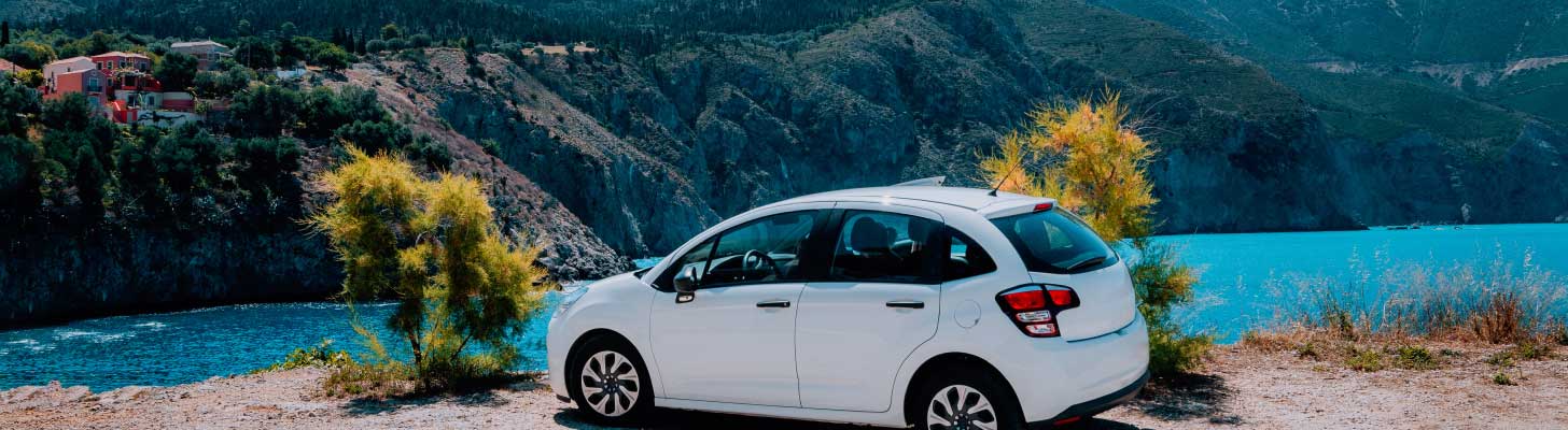 Car parked on a coastal cliff overlooking the sea