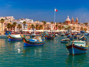 Traditional coloured boats on the water in Malta