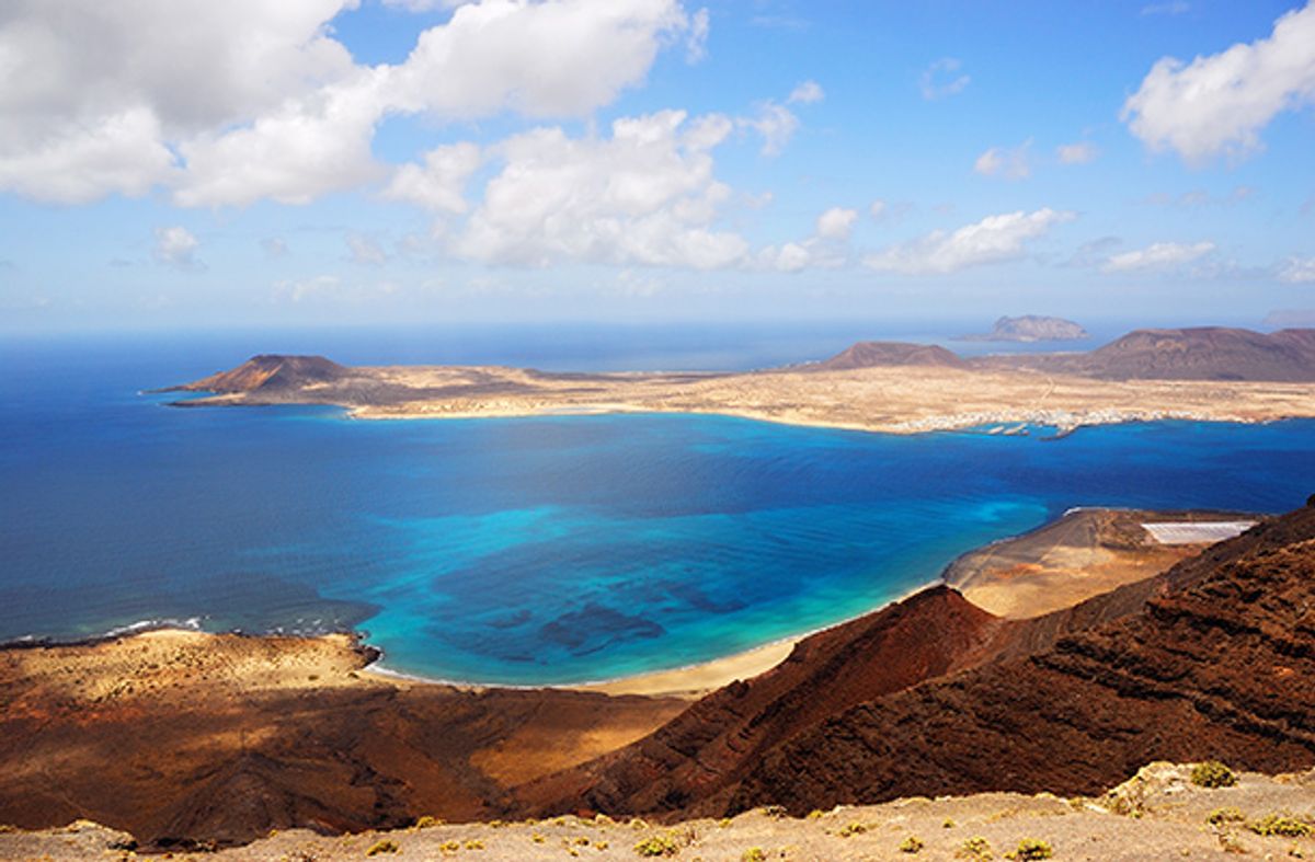 Volcanic landscape in Lanzarote with view of ocean below