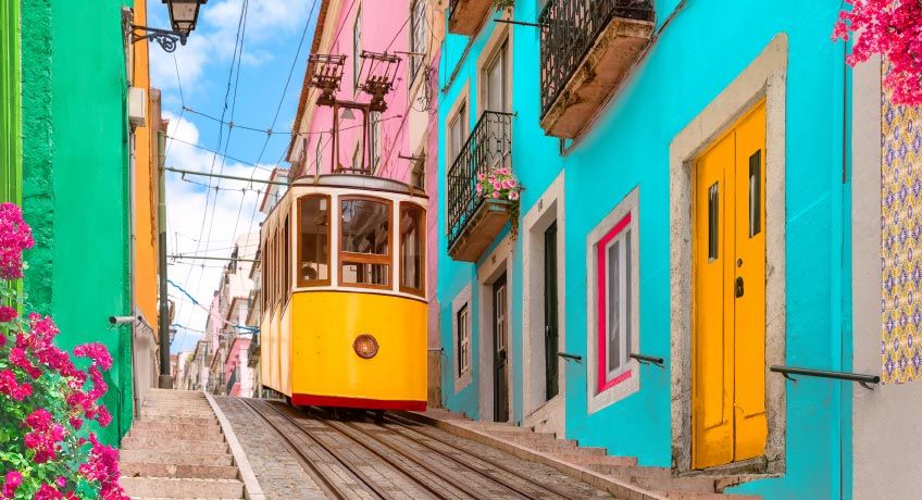 Tram & colourful houses in street in Lisbon