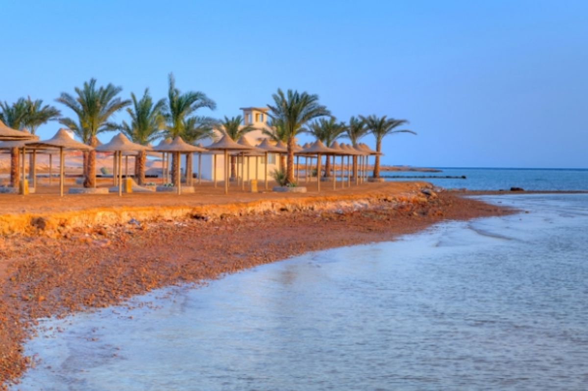 Sunset over a beautiful beach with palm trees in Hurghada, Egypt