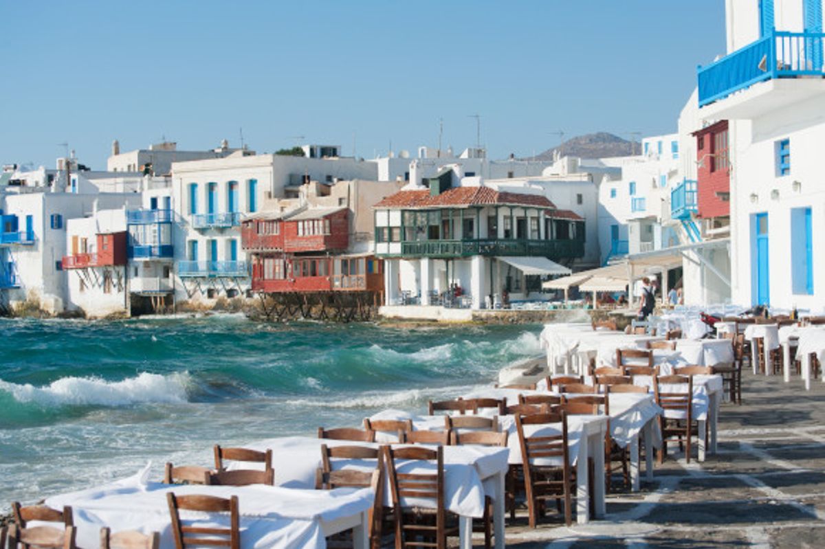 Little Venice in Mykonos with restaurants lining the water's edge and houses sitting over the water