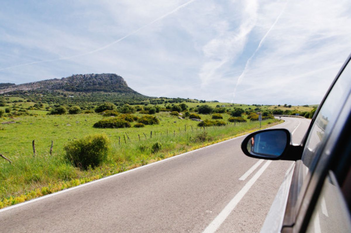 Car driving down a road in Spain taking in the surrounding greenery