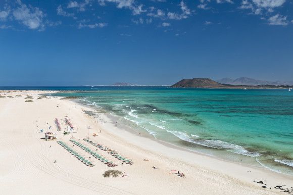 Corralejo Beach on the Canary Island Fuerteventura with a wide body of white sand and clear turquoise waters