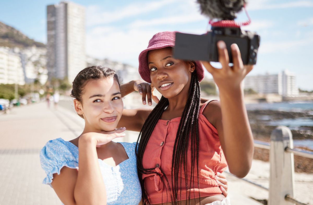 Influencers addressing followers by the seafront