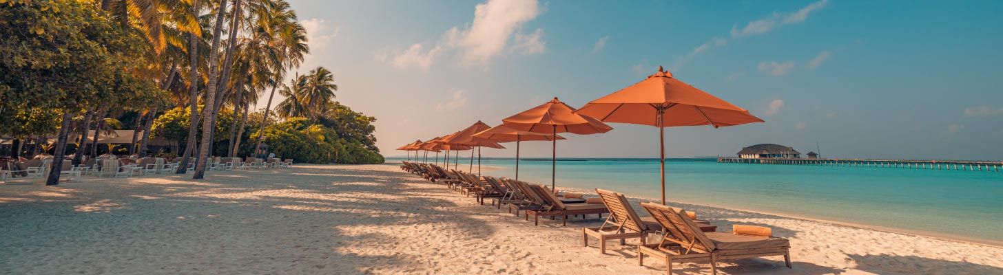 Sun beds & umbrellas on a sandy beach