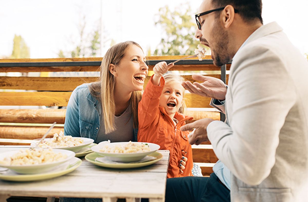 family eating dinner outside