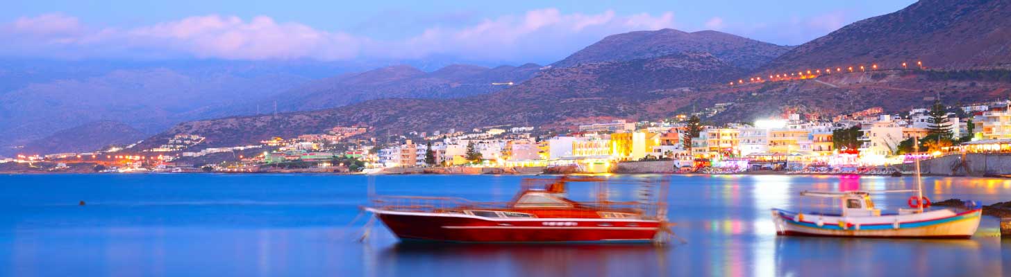 Boats moored off the coast of Hersonissos at sunset