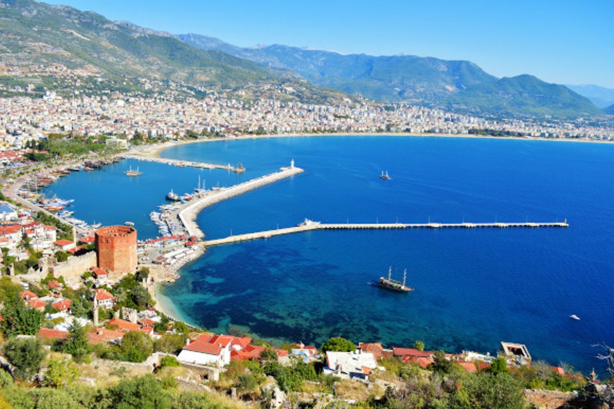 The beautiful Alanya harbor surrounded by azure waters and towering mountains