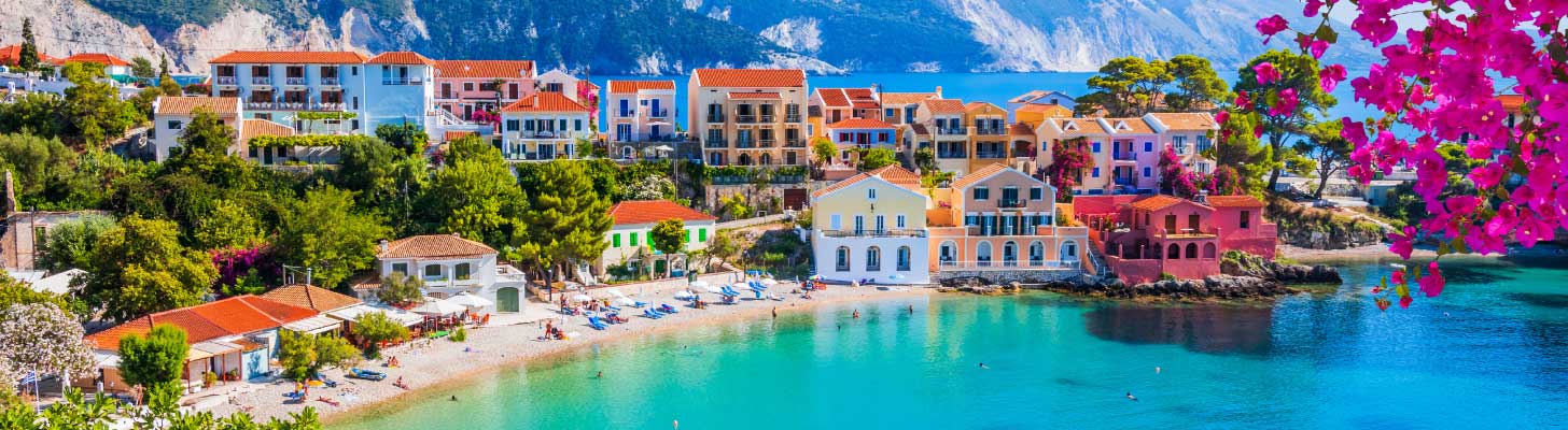 Colourful houses lining the beach in Greece