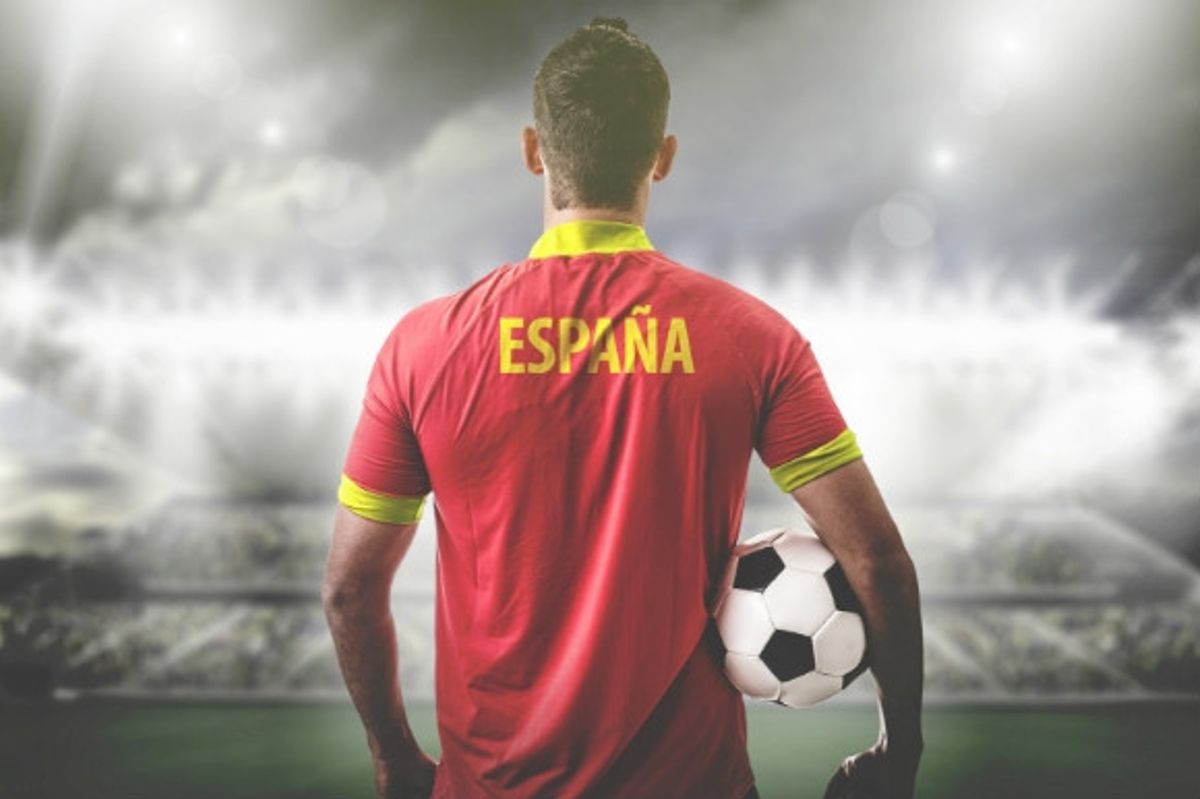 Spanish footballer dominating the stadium overlooking the pitch with a football in hand in Spain.