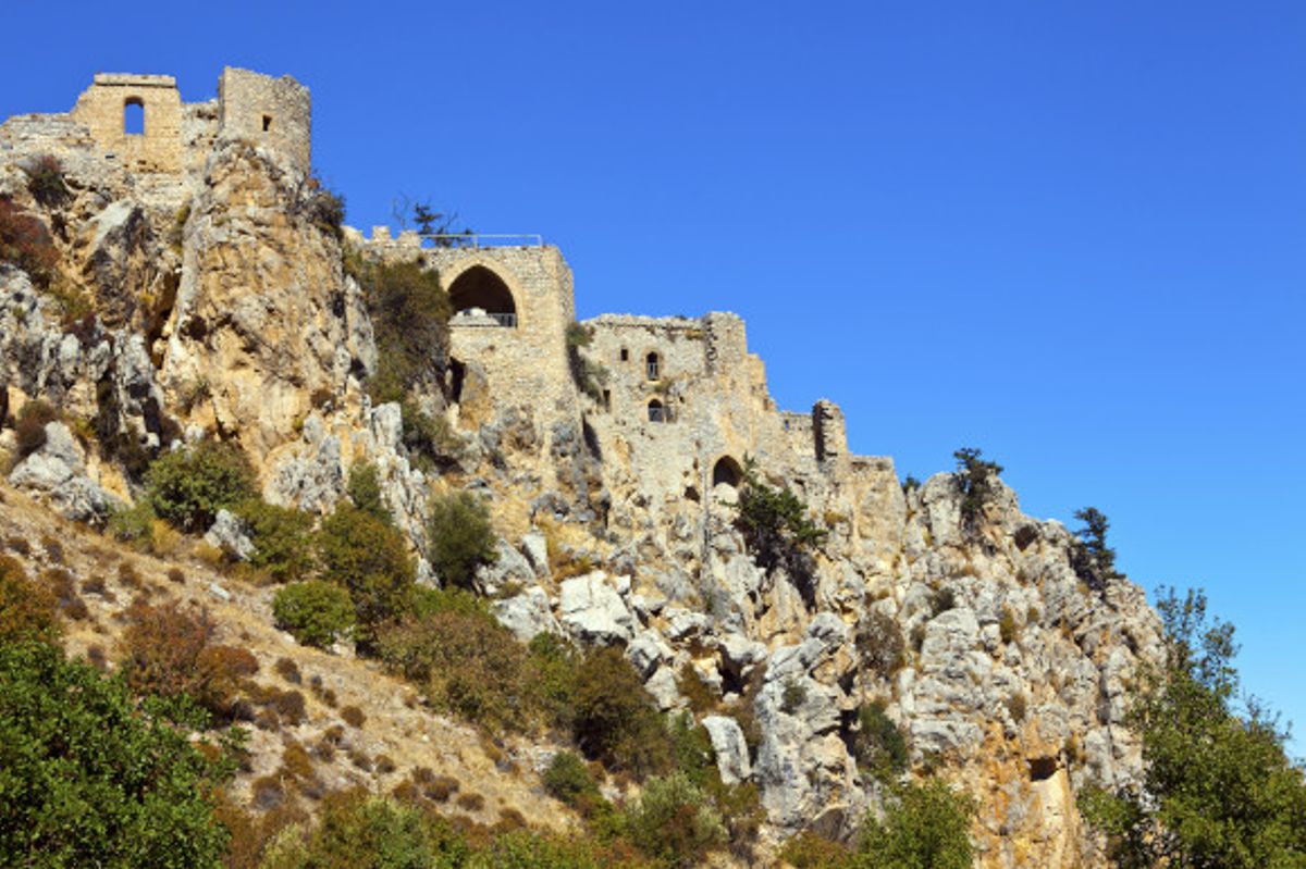 St. Hilarion Castle in Cyprus surrounded by a rocky terrain overgrown with wild bushes
