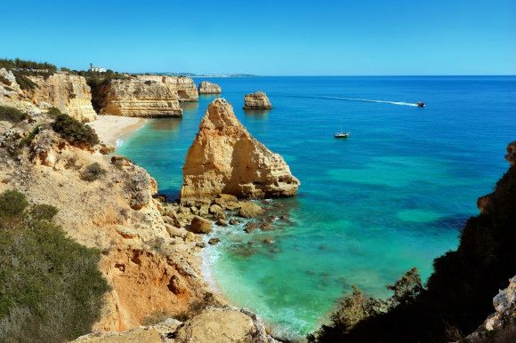 The famous Praia da Marinha Beach in Portugal with limestone cliffs sitting among beautiful, azure waters