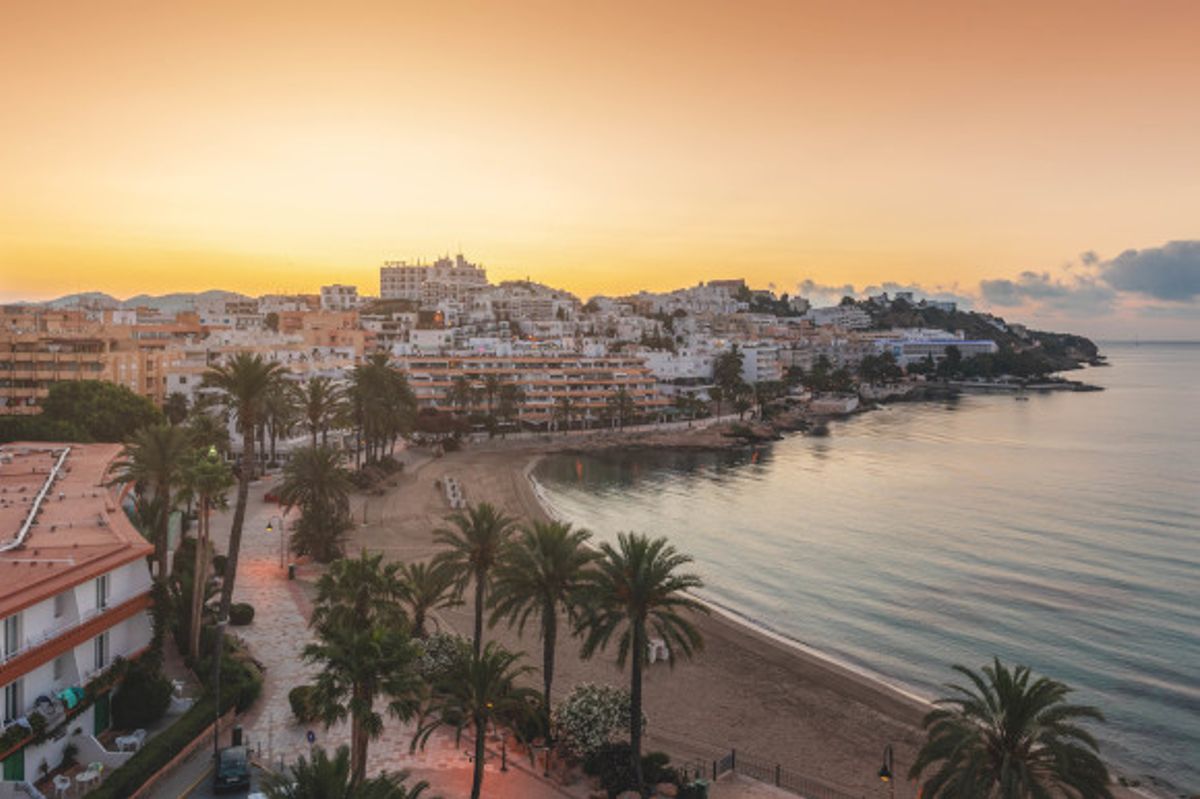 A stunning sunset view of the beach in Figueretas on the island of Ibiza