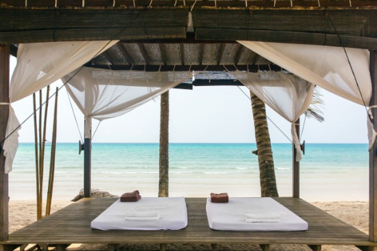 Beach massage wooden hut with two massage beds.