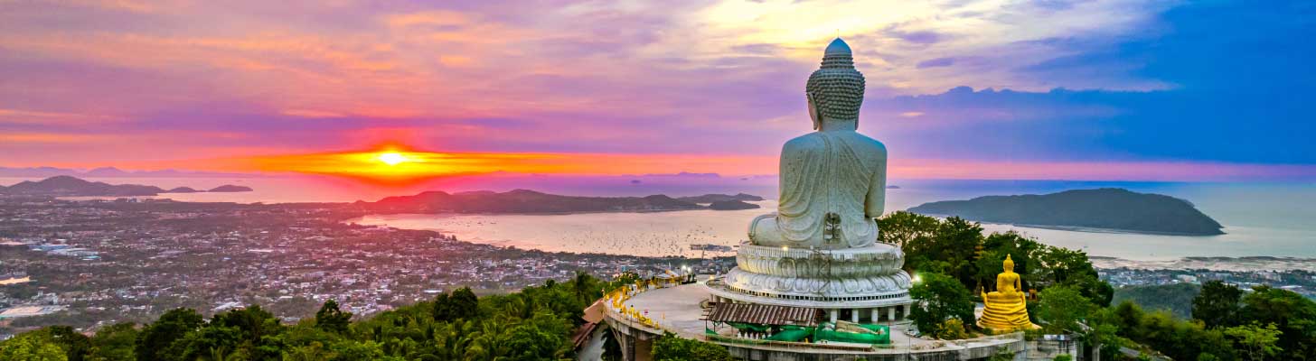 Giant buddha overlooking Phuket at sunset