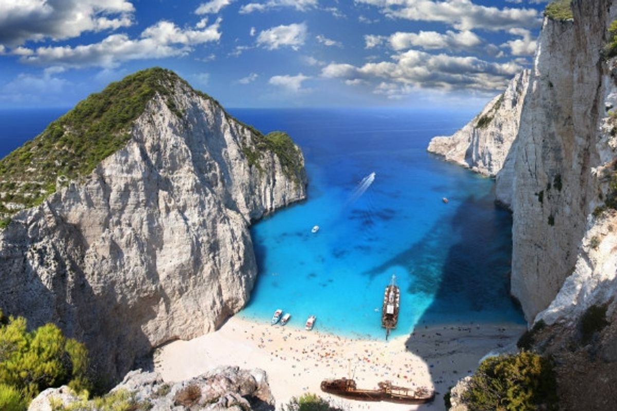 Also known as 'Shipwreck Beach' for its shipwreck in the middle of its white sand and clear blue waters. Navagio Beach is in Zakynthos Greece.