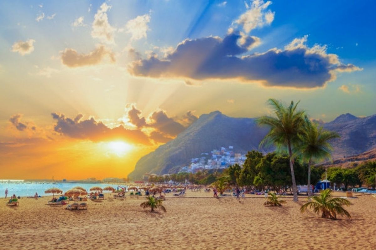 Sunset along the lunar landscape and golden shoreline of Tenerife, Canary Islands.