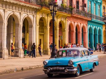 Vintage American car driving down the street in Cuba