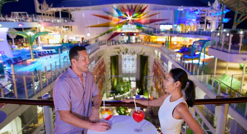 Couple enjoying drinks on board the Icon of the Seas