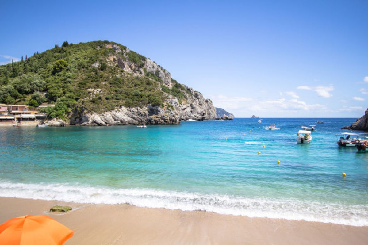 The beautiful Agios Spyridon in Corfu surrounded by lush greenery and lapping waves