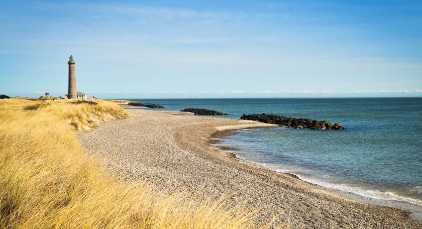 Lighthouse on the sandy shore in Skagen, Denmark
