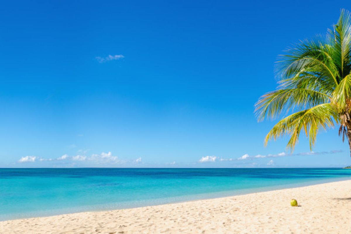 Sandy Lane in Barbados with far-stretching white sands and Caribbean waters surrounded by a blue sky