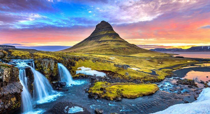 The Kirkjufellsfoss waterfall in Grundarfjordur at sunrise