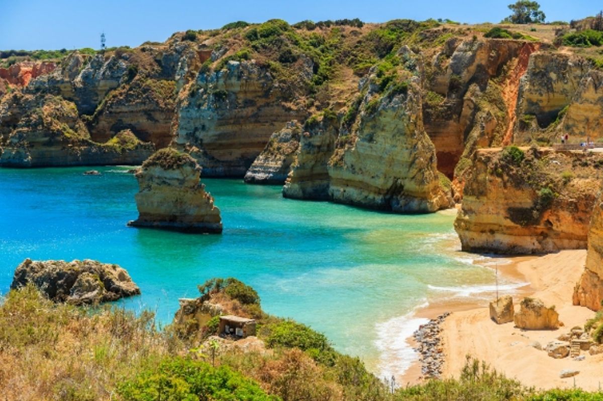 Portugal's famous Praia Dona Ana Beach with stunning views of the surrounding cliffs and clear blue water