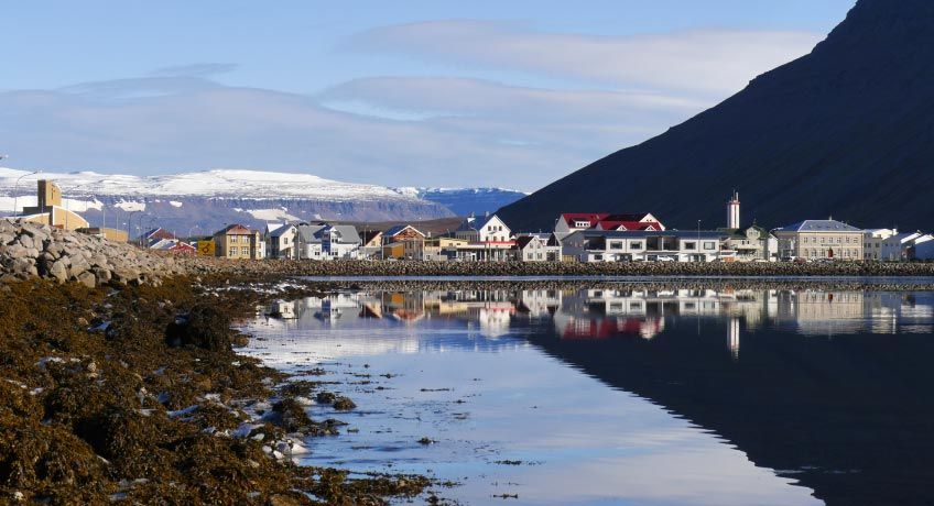 Snow capped hills & traditional houses in Isafjordur, Iceland