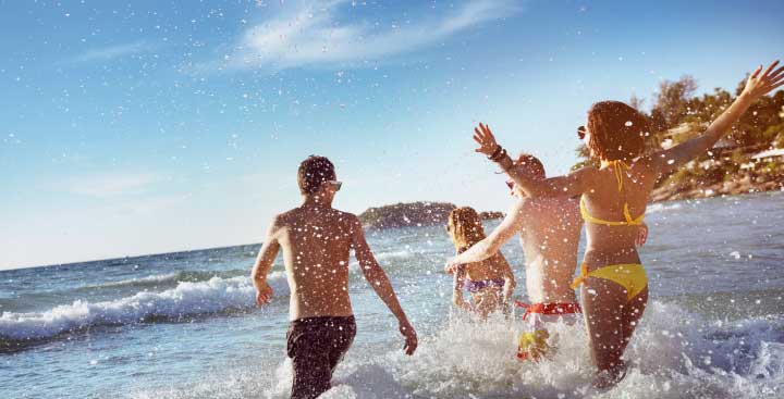Friends running into the sea