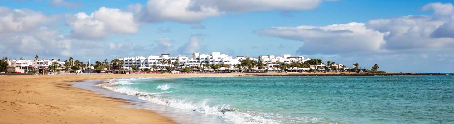 Golden sands of Playa de los Pocillos beach in Lanzarote
