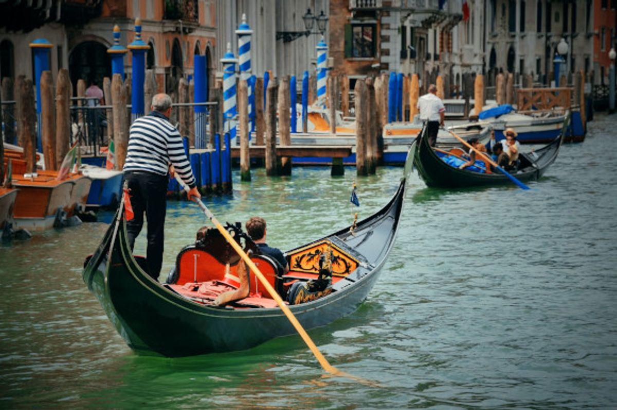 Couple enjoying a romantic gondola ride over the famous waterways of Venice in Italy