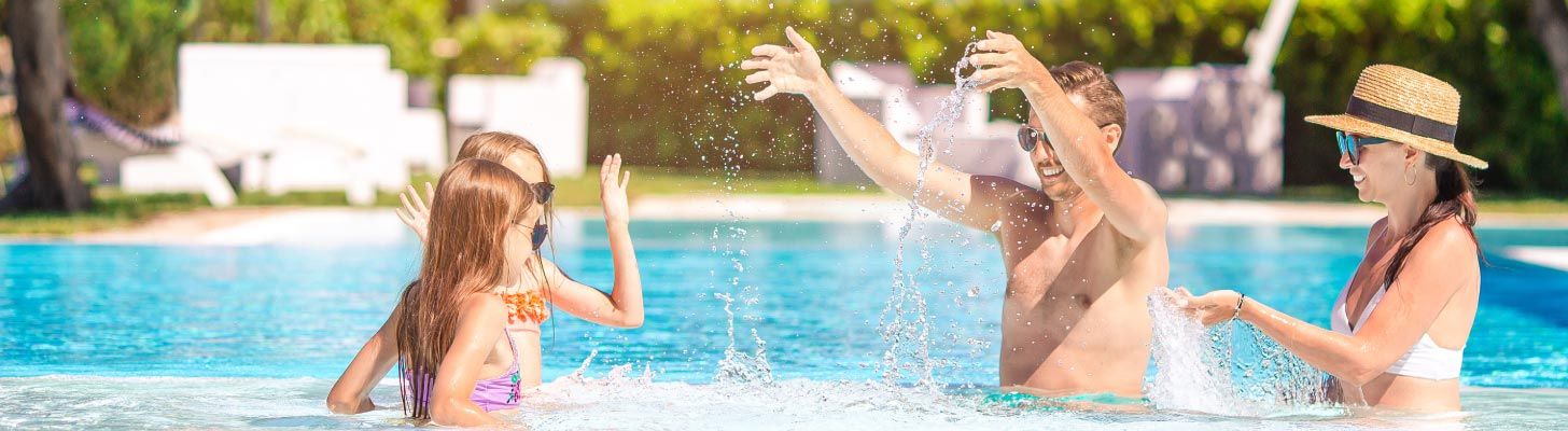 Family playing in a swimming pool