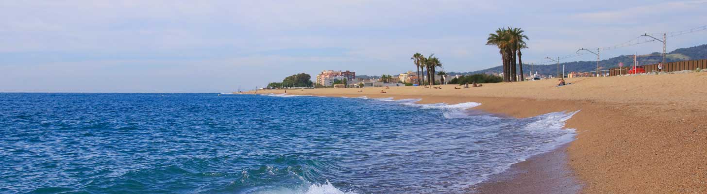Golden sands & blue sea of a beach in Santa Susanna, Costa Brava