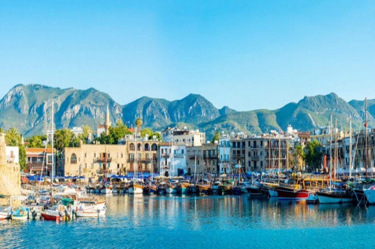 The stunning backdrop of Kyrenia Harbour in Cyprus with its quaint boats and waterfront restaurants.