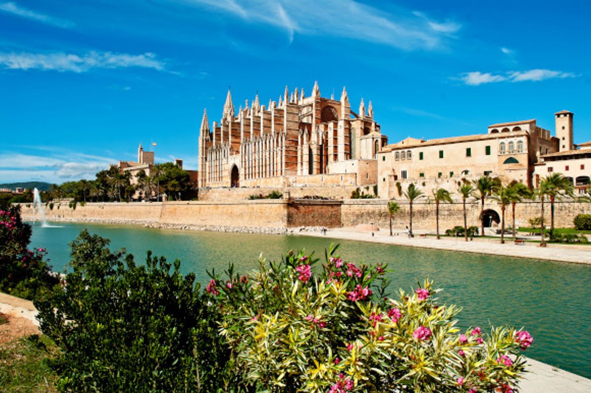 A beautiful view of the famous Cathedral of Palma de Majorca surrounded by water