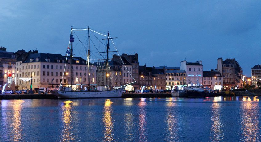 Tall ship in the harbour at night in Cherbourg, France