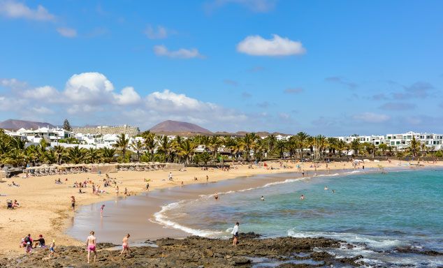 Holiday makers on the beach in Costa Teguise, Lanzarote