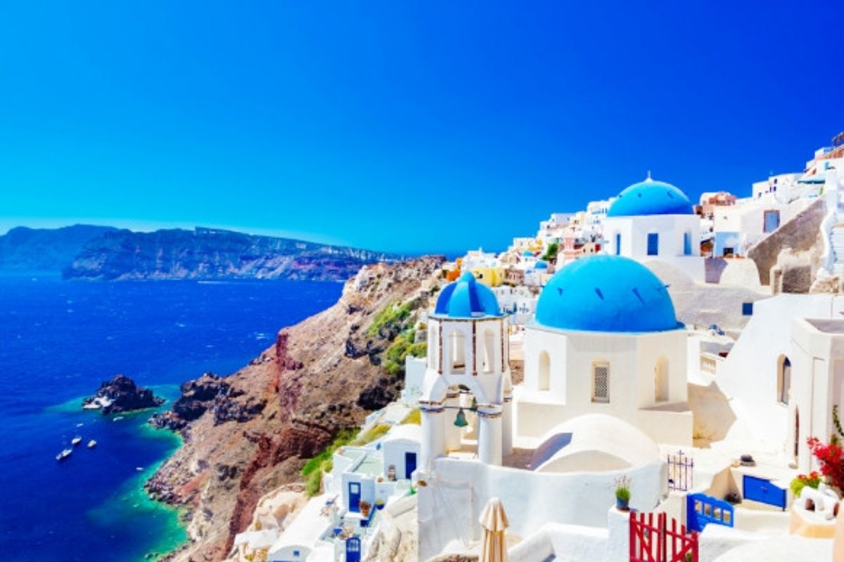 The blue-domed whitewashed village of Oia in Santorini,Greece.