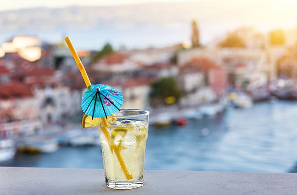 Cocktail with blurred Croatian town in background