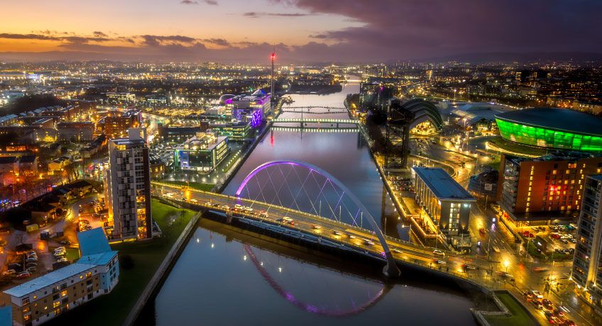 Bridges over the river Clyde lit up at night in Glasgow