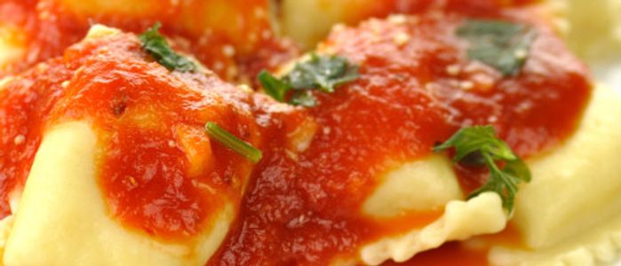 Plate of three cheese ravioli with sauce