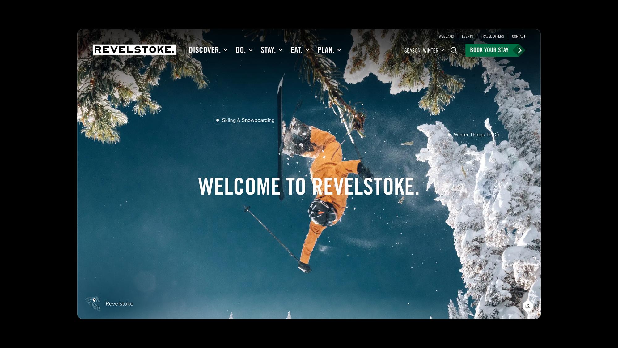 The seerevelstoke.com home page in winter: a skier mid-air above snowy trees, with pins linking to skiing and winter things to do