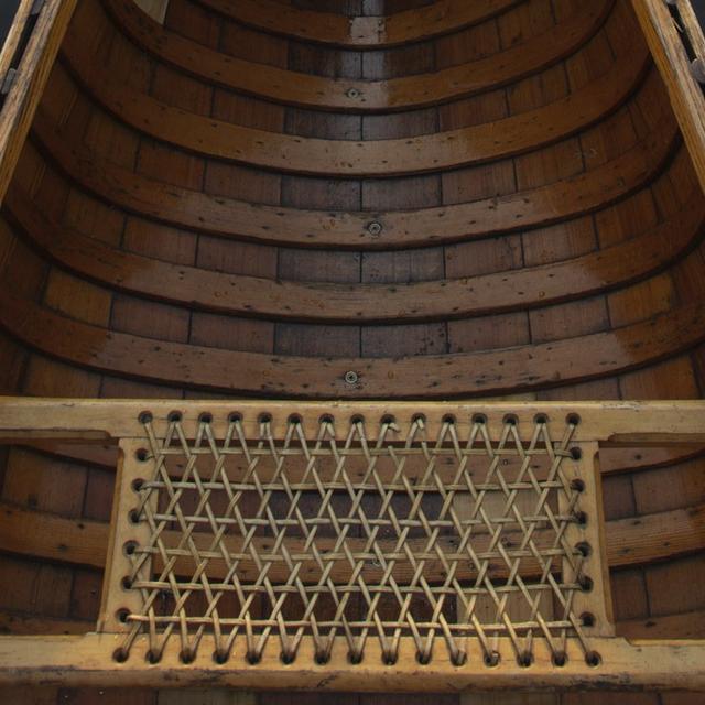 Looking down the length of a wooden canoe